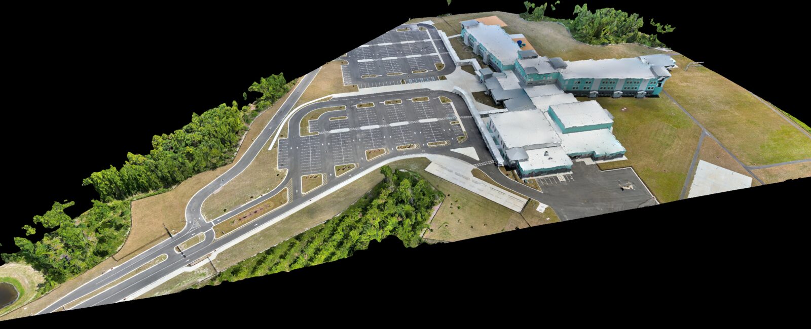 Textured 3D mesh reconstruction of a completed Northeast Florida site, with building massing, parking field, and grade rendered as a measurable model.