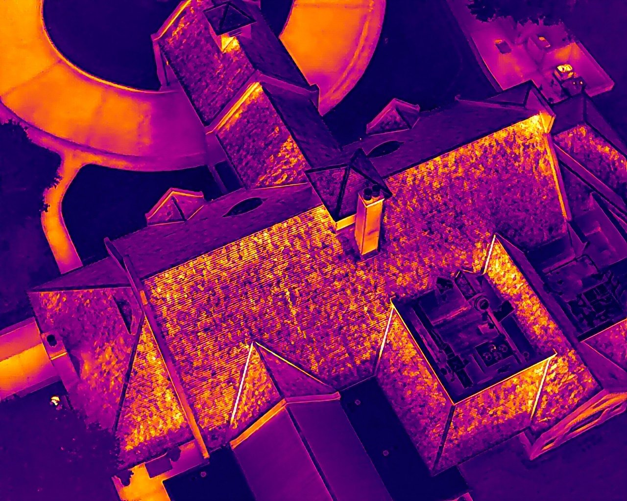 Radiometric thermal capture of the same roof showing heat differentials and moisture patterns per ASTM C1153-23